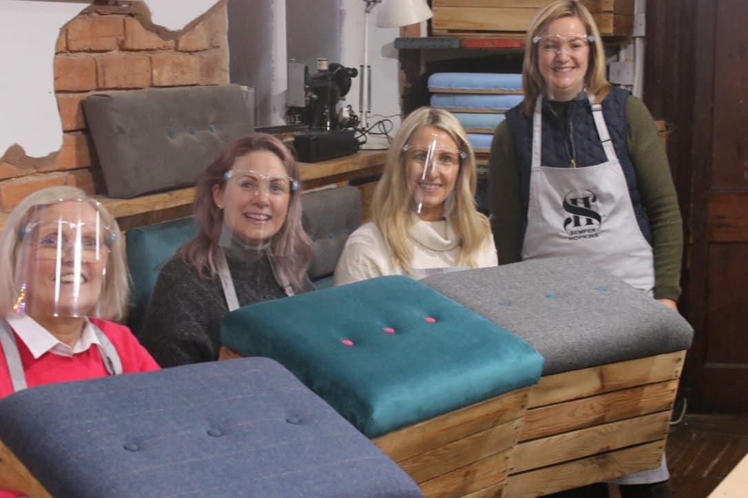 Emma with clients at upholstery workshop.