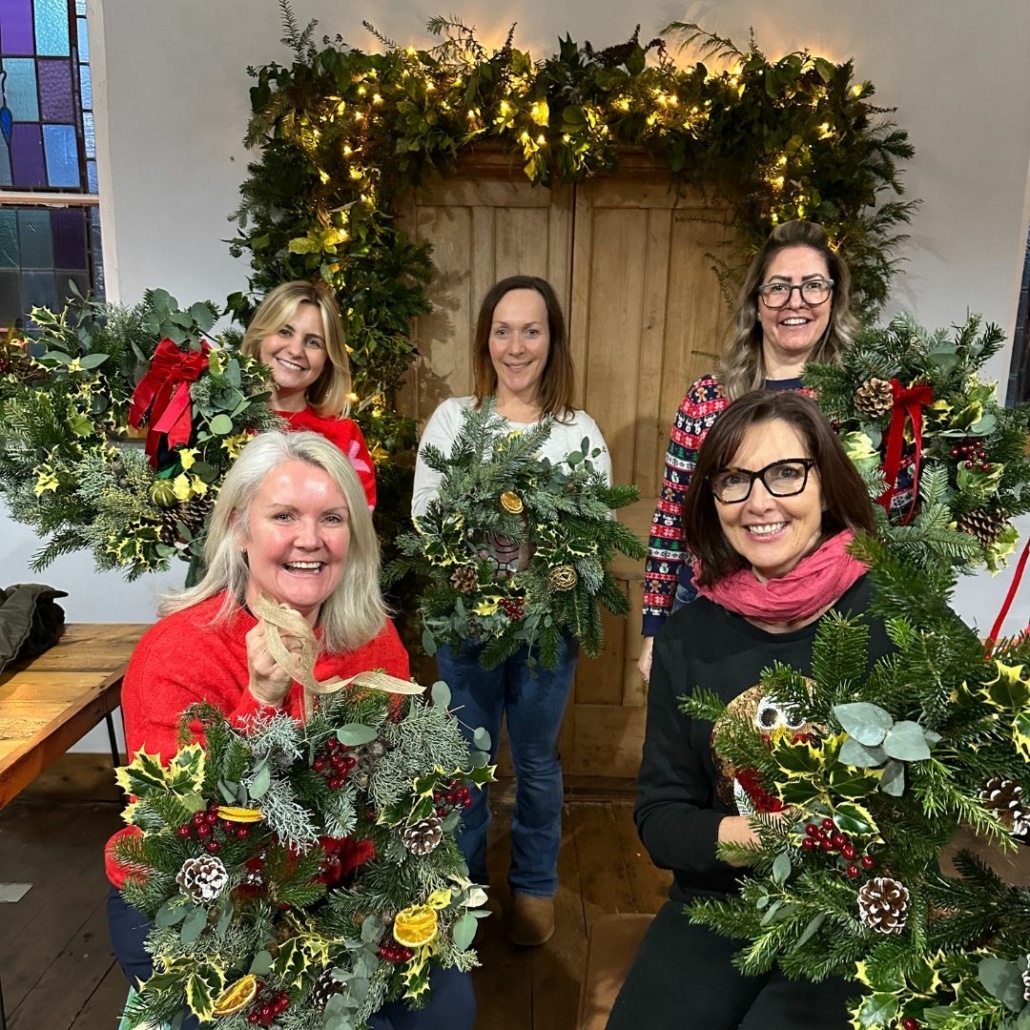 Group of ladies holding their festive wreaths