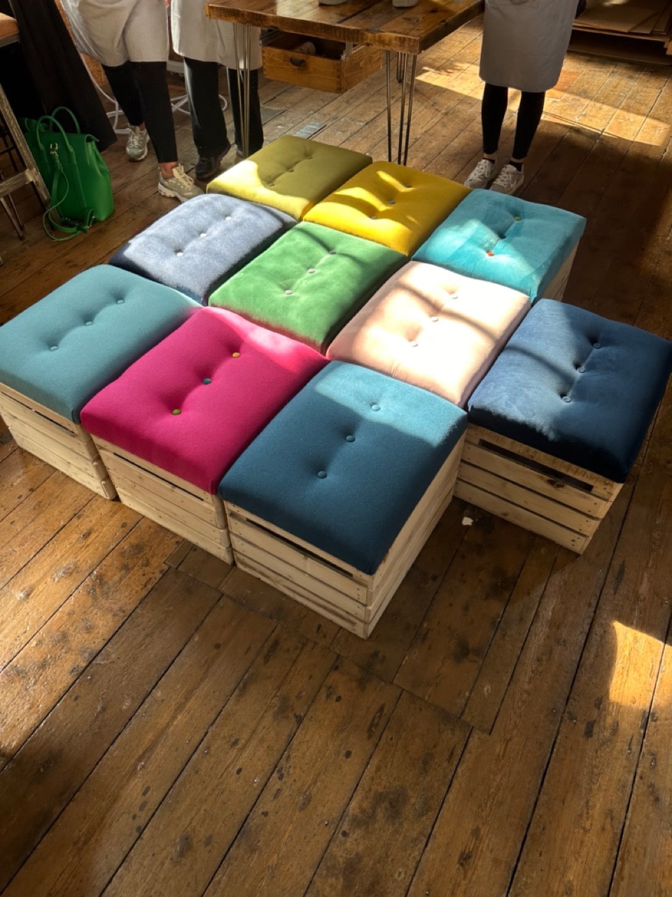Handmade storage crates created during a creative team building upholstery workshop.
