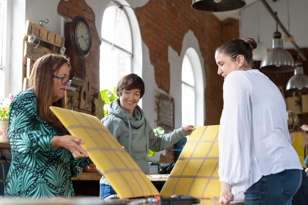 A group of ladies taking part in a noticeboard team building day