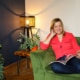 Emma Semper Hopkins sat on a sofa in her home, that she has upholstered.