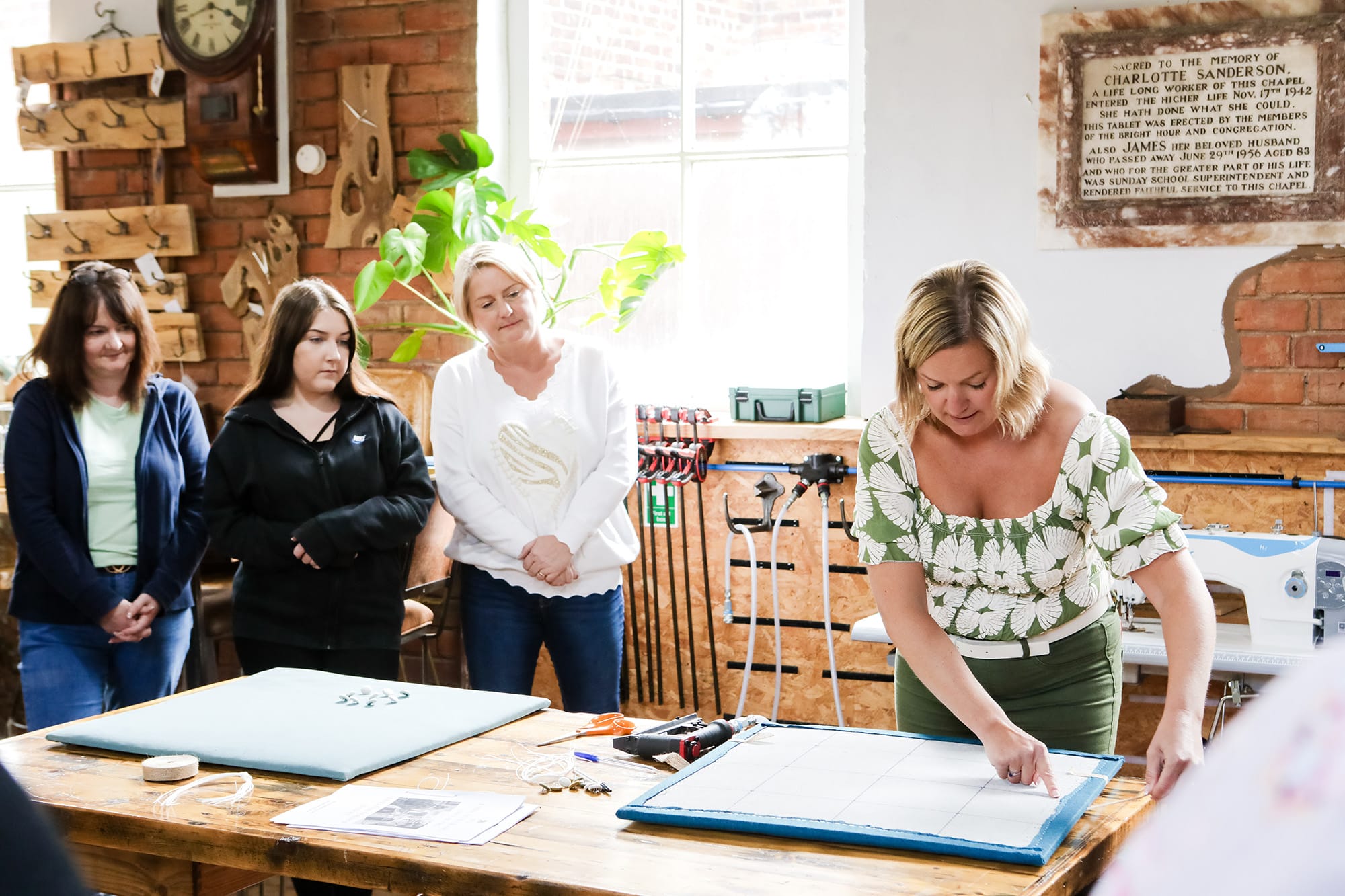 Team members working together on an upholstery project during a team building workshop in Cheshire.