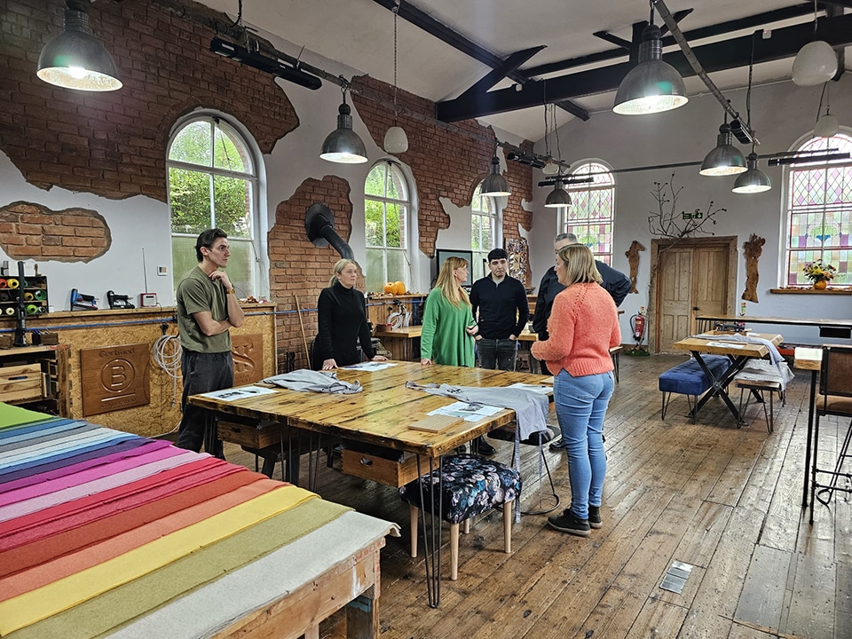 Apollo Care team members designing and upholstering their own noticeboards during a hands-on creative workshop.