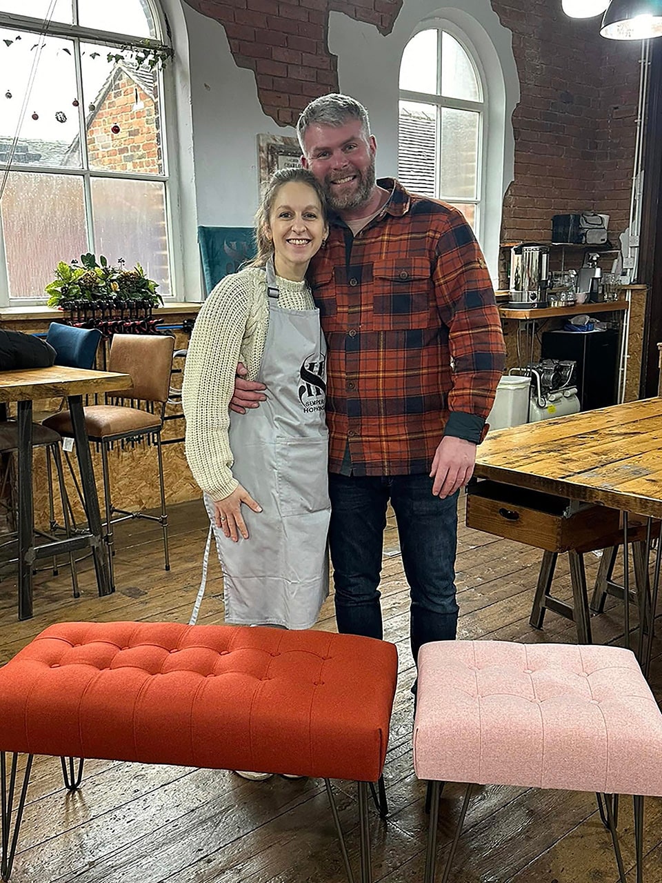 A couple together during an upholstery workshop, choosing fabrics and assembling their project side by side.