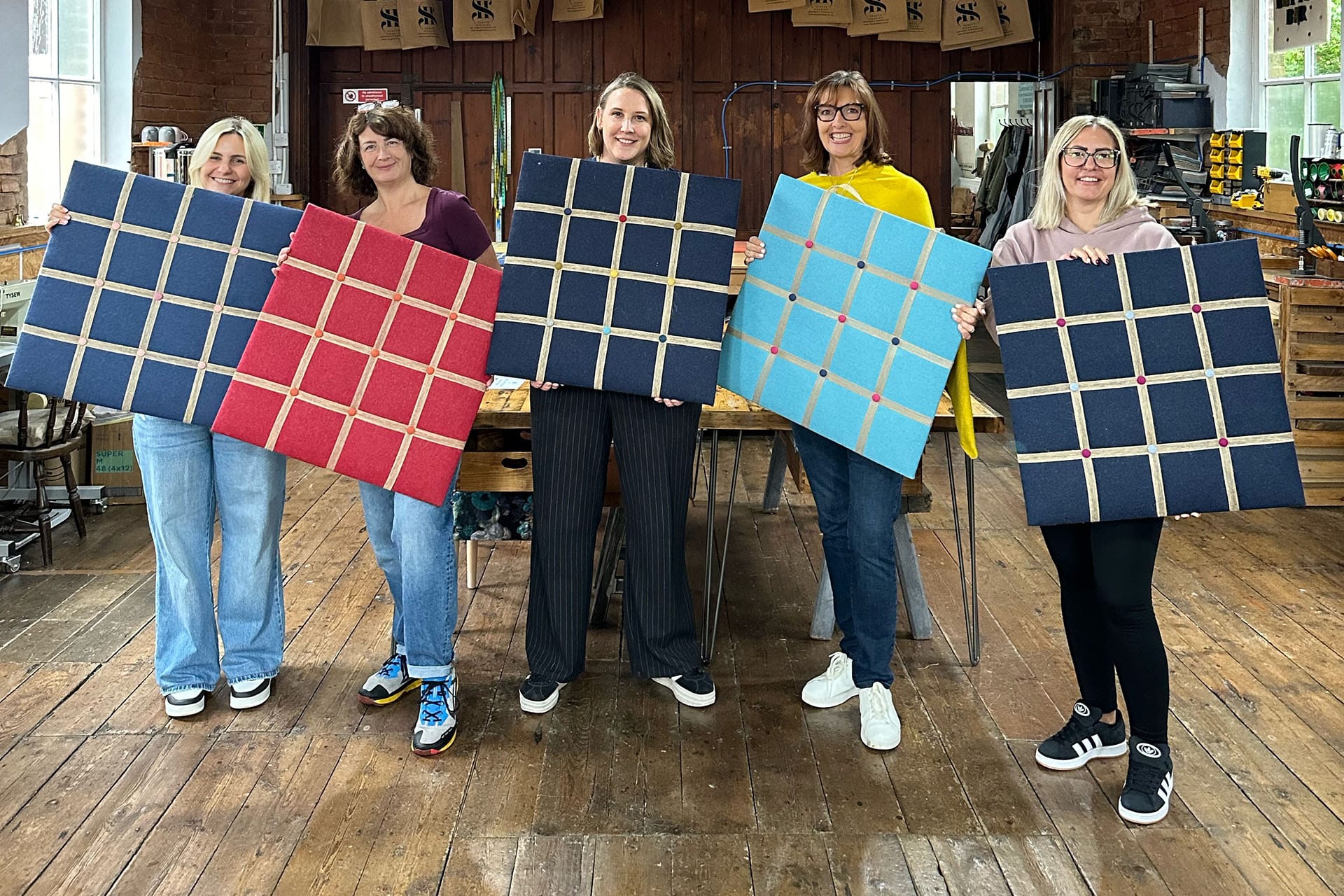 P3 People Management team holding handmade noticeboards after their creative team day at SHUI.
