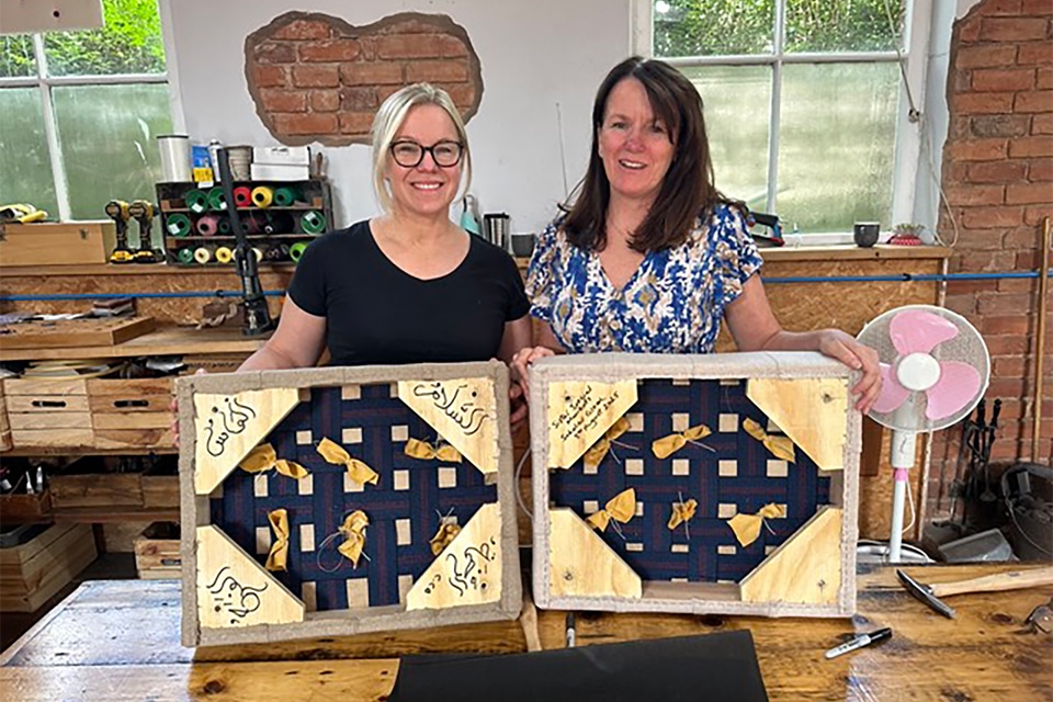 Tori and Claire sisters taking part in a creative workshop, chatting and supporting each other while crafting their pieces.
