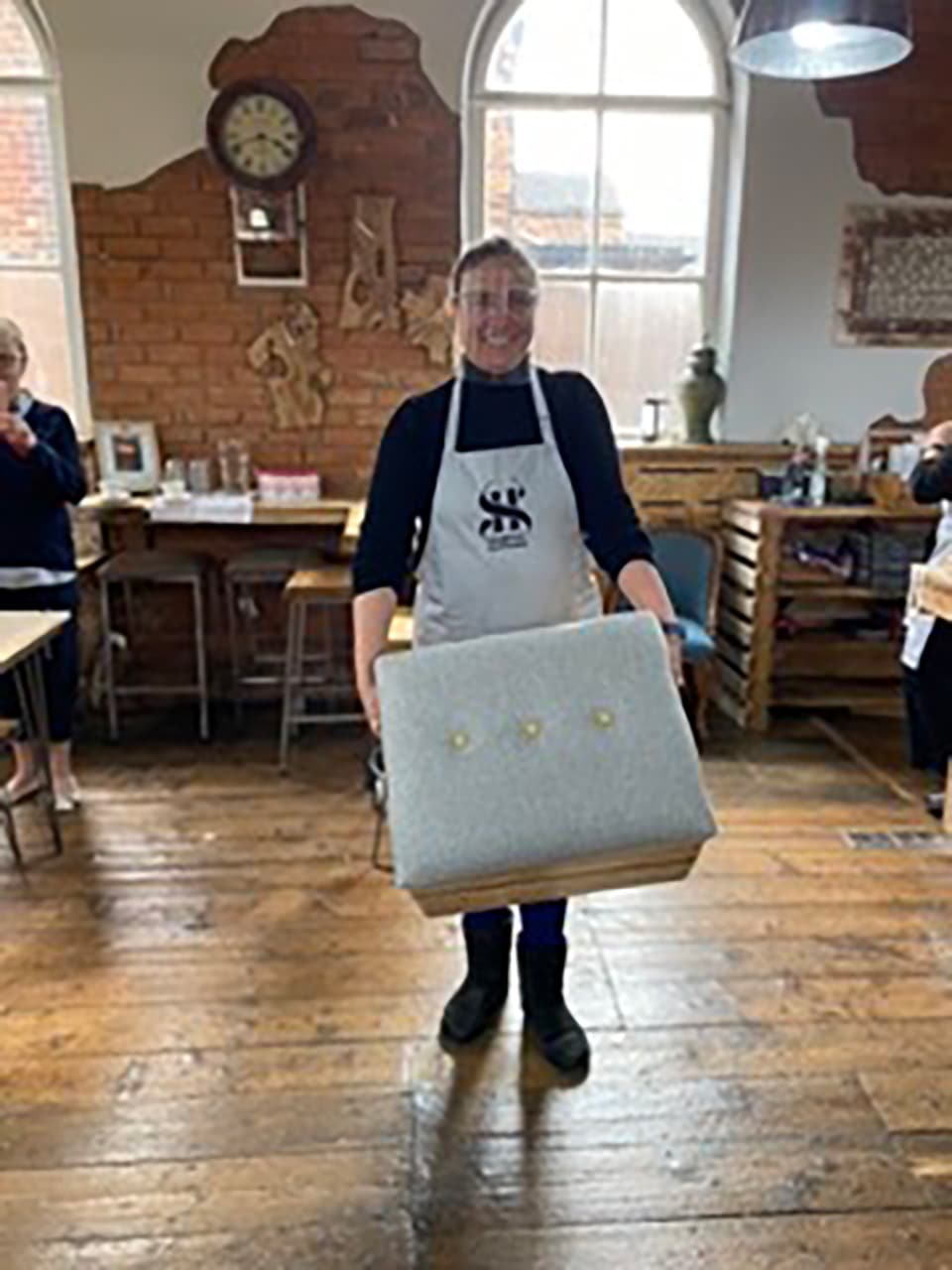 ros-finished-crate-workshop-2021 Ros proudly holding the upholstered crate she made during her workshop in the chapel.