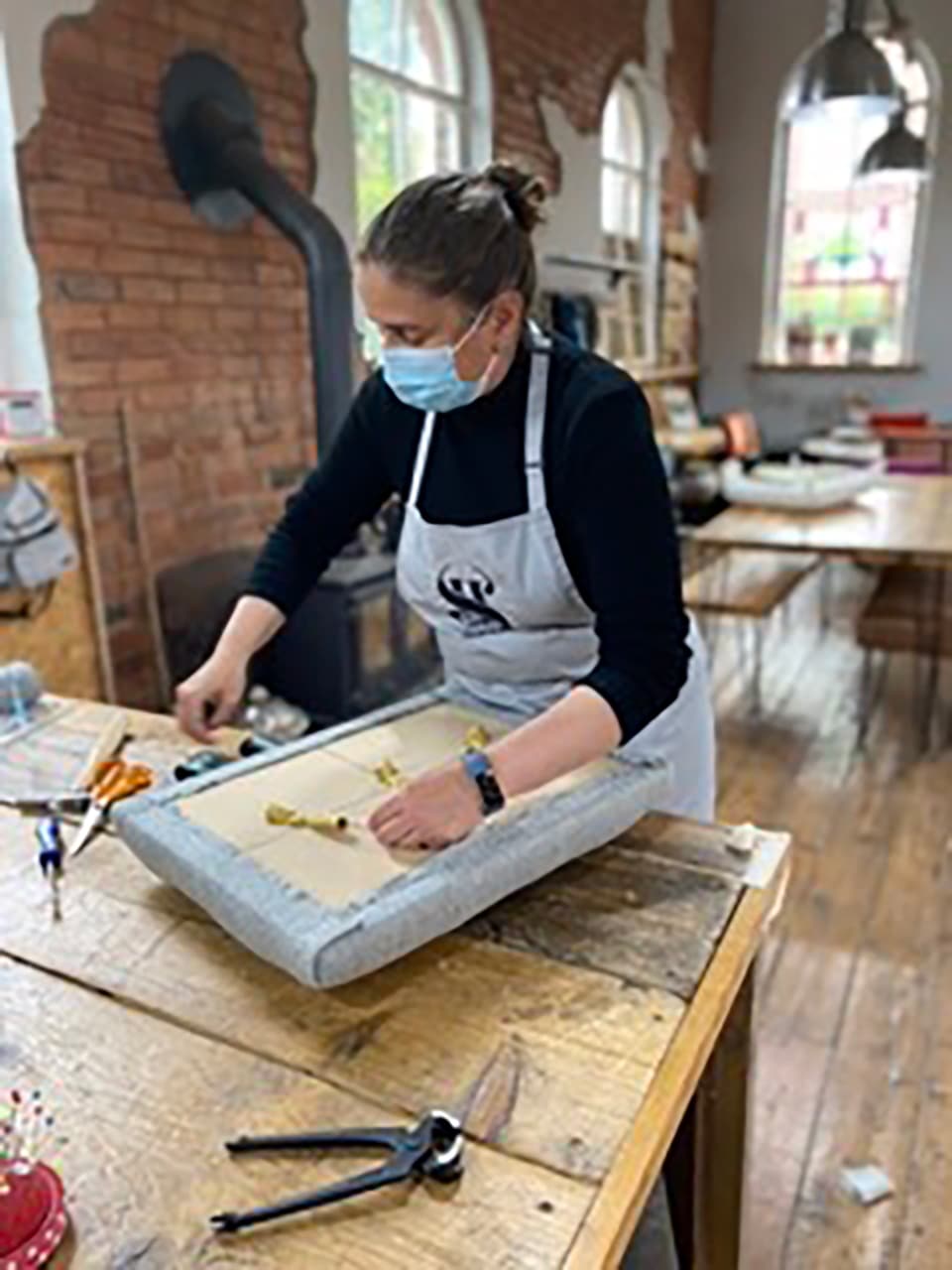 ros-upholstery-workshop-creating-2021 Ros working on her crate project during her 2021 upholstery workshop, focused at her bench inside the chapel.