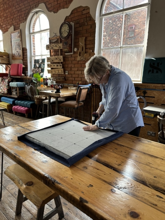 Upholstering fabric noticeboard