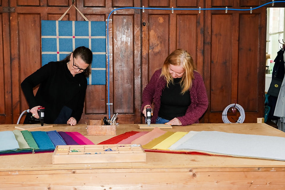 Hands working side-by-side during a creative team away day to build connection