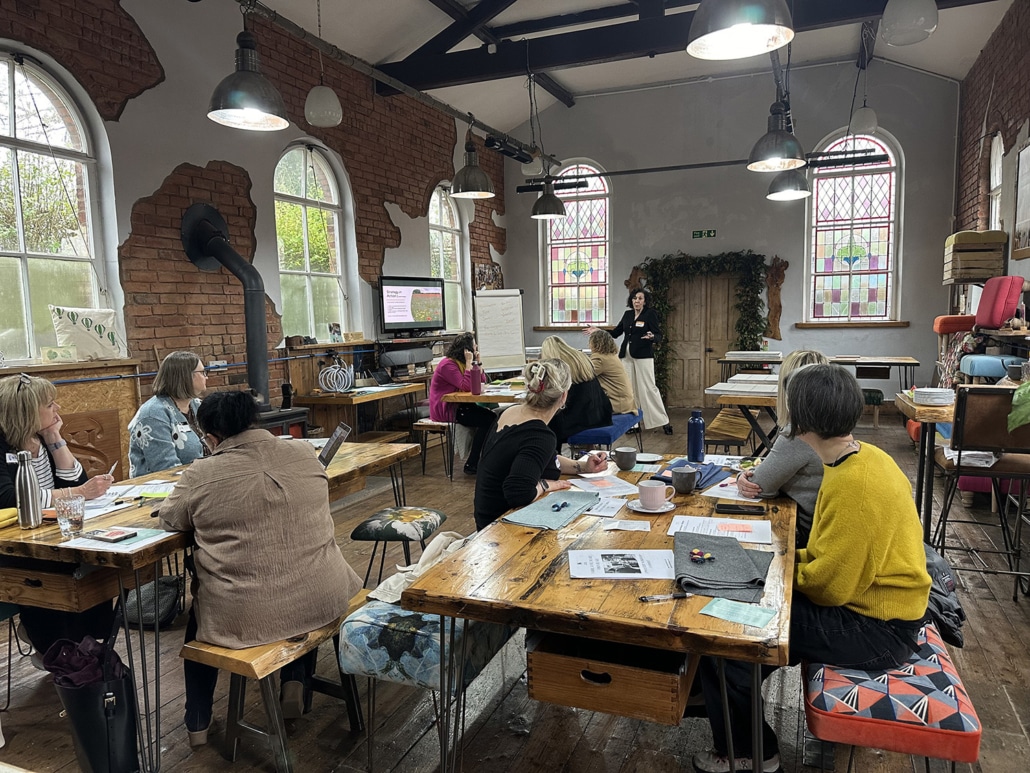 Facilitated workshop in Kent Green Chapel, a light-filled creative space in Cheshire with small groups engaged in discussion and learning