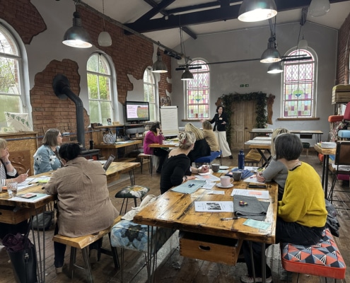 Facilitated workshop in Kent Green Chapel, a light-filled creative space in Cheshire with small groups engaged in discussion and learning