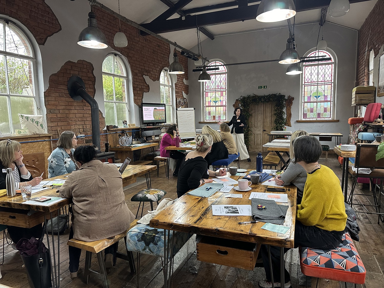 Facilitated workshop in Kent Green Chapel, a light-filled creative space in Cheshire with small groups engaged in discussion and learning