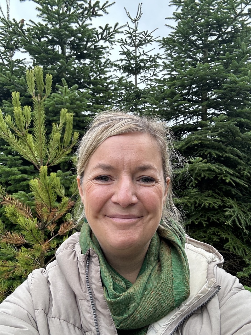 Emma Semper Hopkins visiting Woodside Christmas Trees in Cheshire to source foliage for wreath workshops Walking amongst the trees at Woodside Christmas Trees.